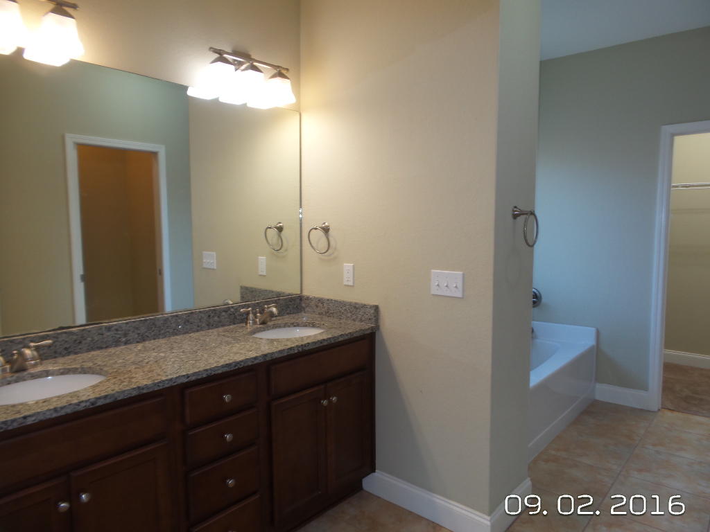 4589 Hermosa Road Crestview, FL 32539 - Photo 15 of 21 a bathroom with a granite countertop sink and a mirror