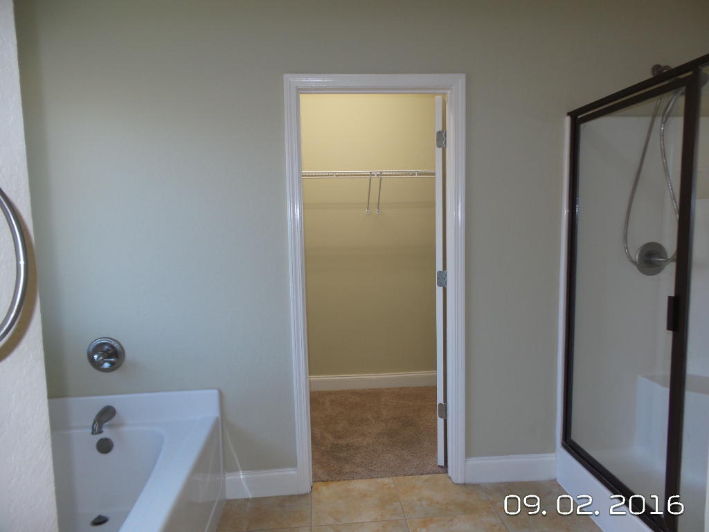 4589 Hermosa Road Crestview, FL 32539 - Photo 16 of 21 a bathroom with a bathtub and a shower
