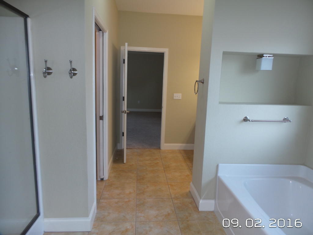 4589 Hermosa Road Crestview, FL 32539 - Photo 17 of 21 a bathroom with a tub shower and vanity