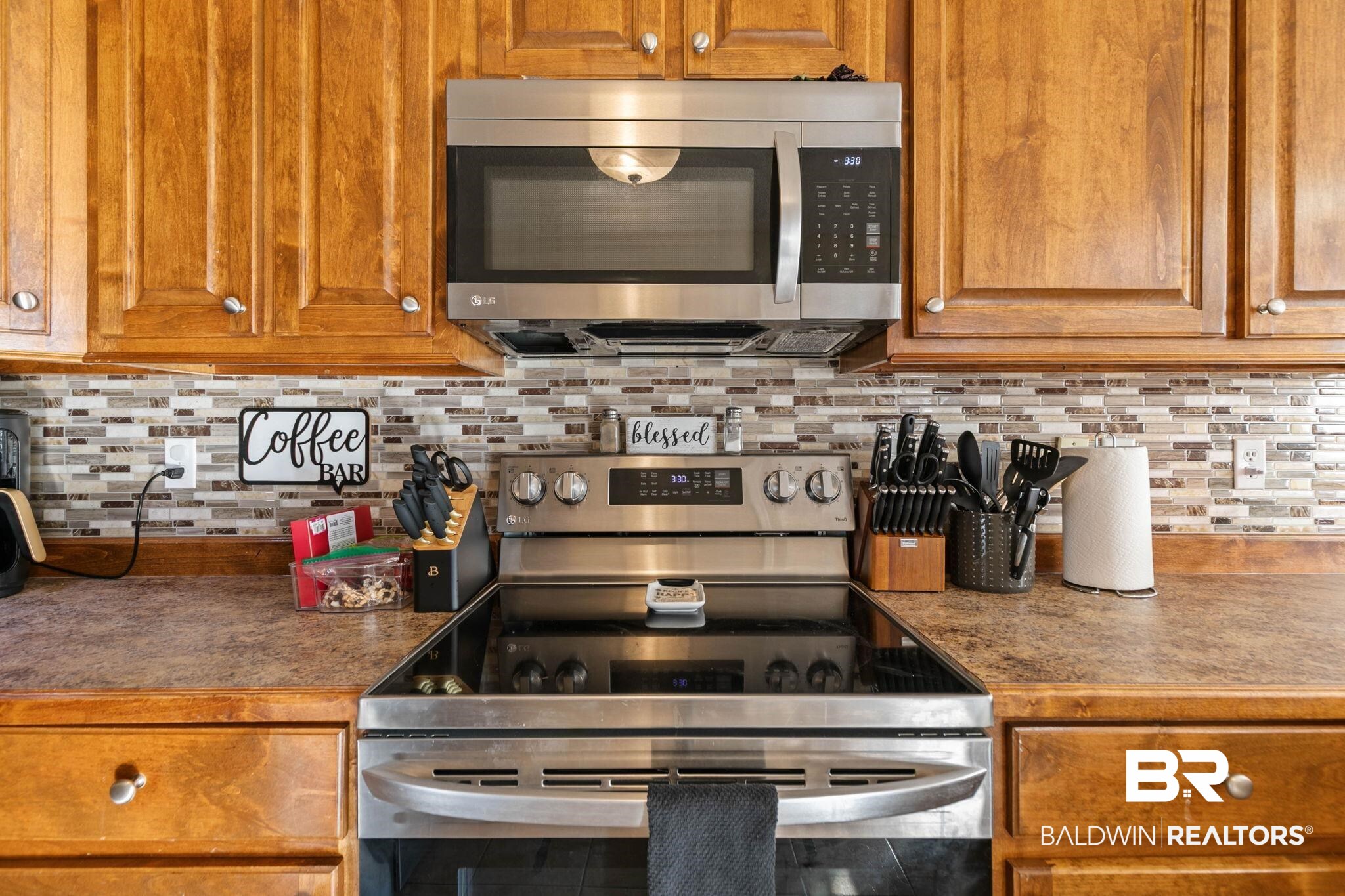 55750 Lottie Road Perdido, AL 36562 - Photo 63 of 84 Kitchen with stainless steel appliances, wood finish cabinets, and decorative backsplash