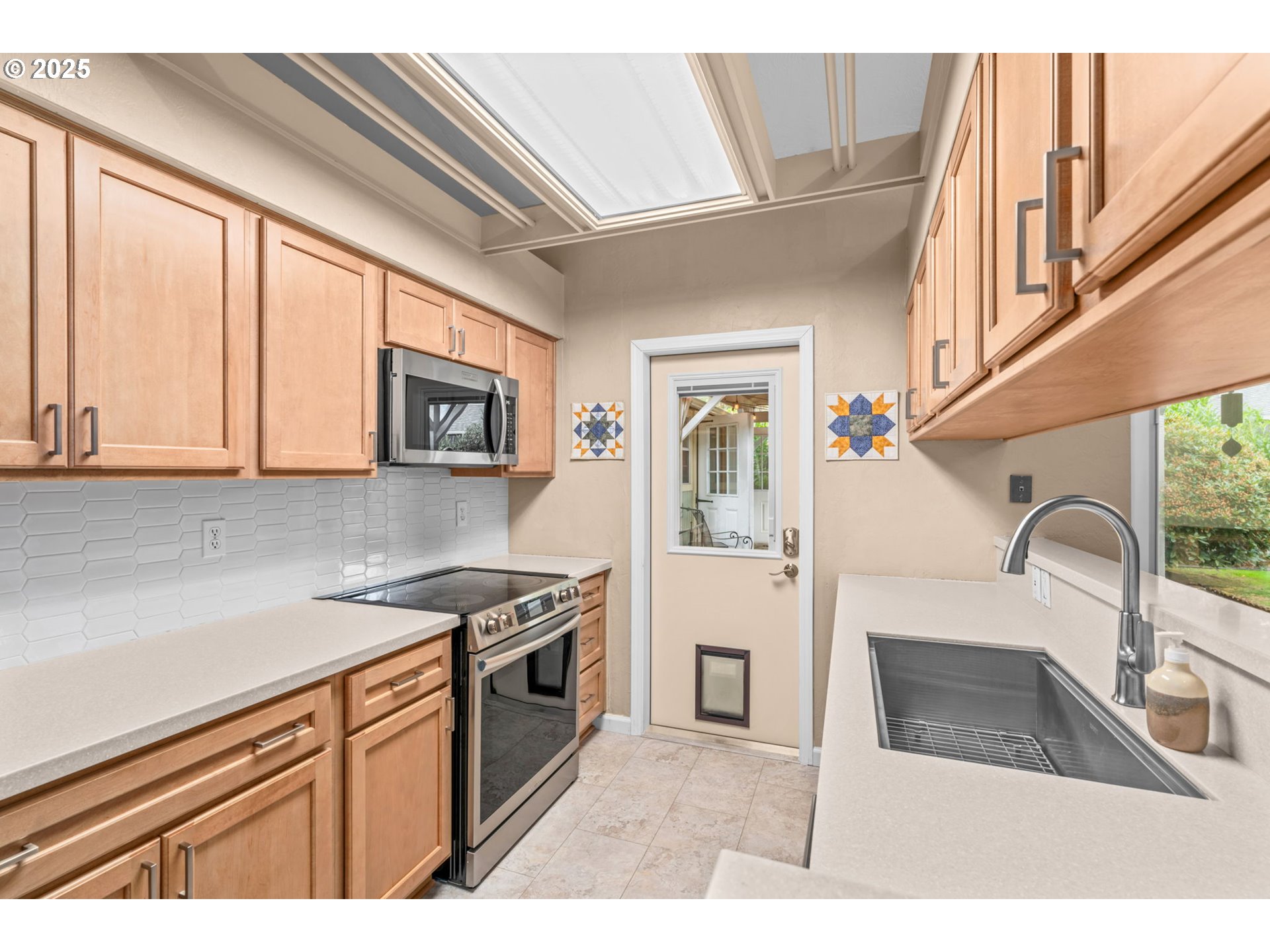 2180 Southeast Madison Street Albany, OR 97322 - Photo 11 of 28 a kitchen with stainless steel appliances granite countertop a stove a sink and a microwave