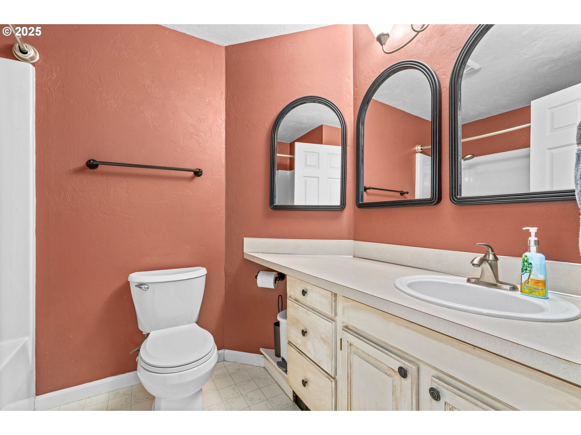 2180 Southeast Madison Street Albany, OR 97322 - Photo 15 of 28 a bathroom with a toilet sink and mirror