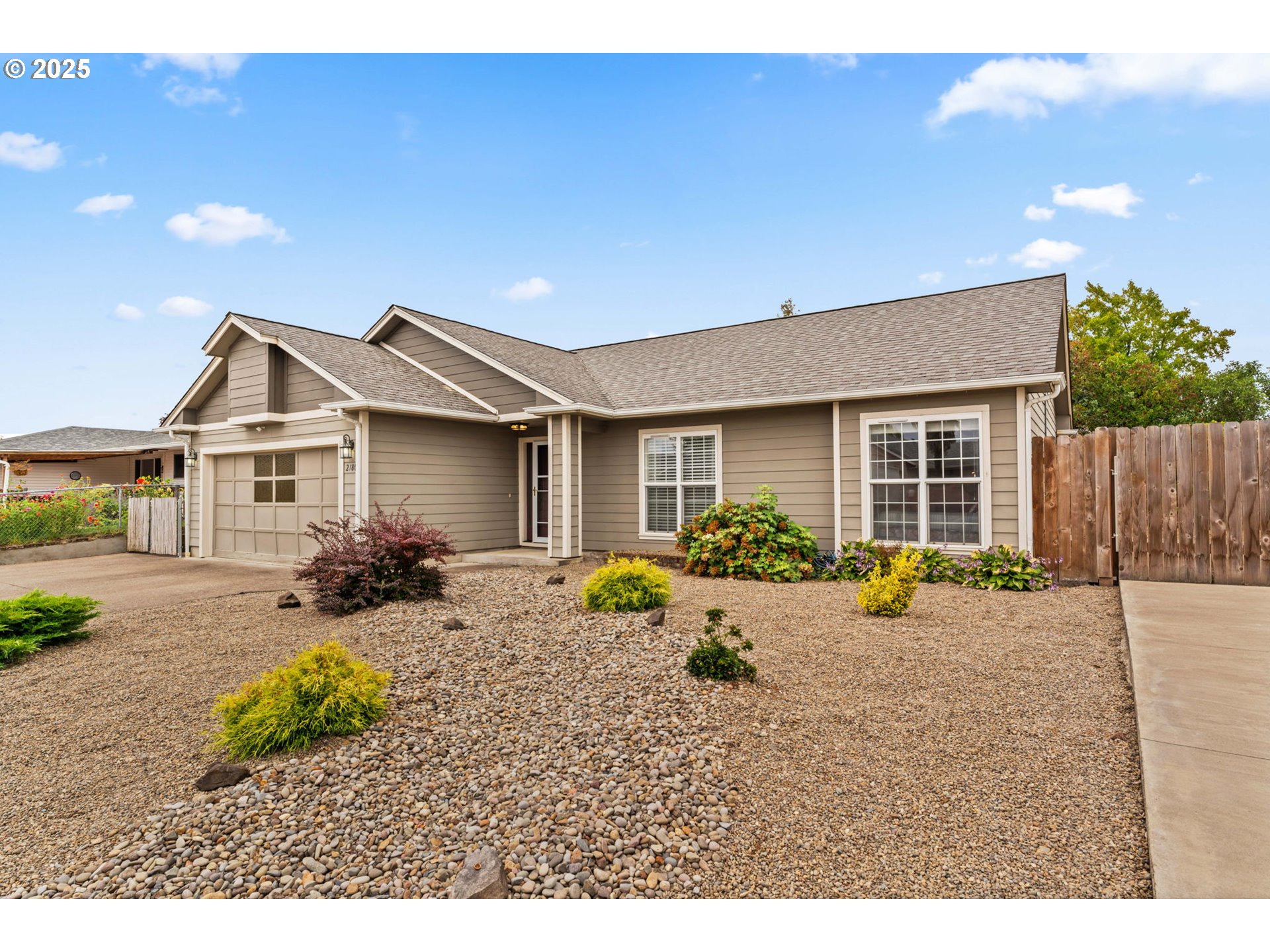 2180 Southeast Madison Street Albany, OR 97322 - Photo 2 of 28 a backyard of a house with wooden table and chairs