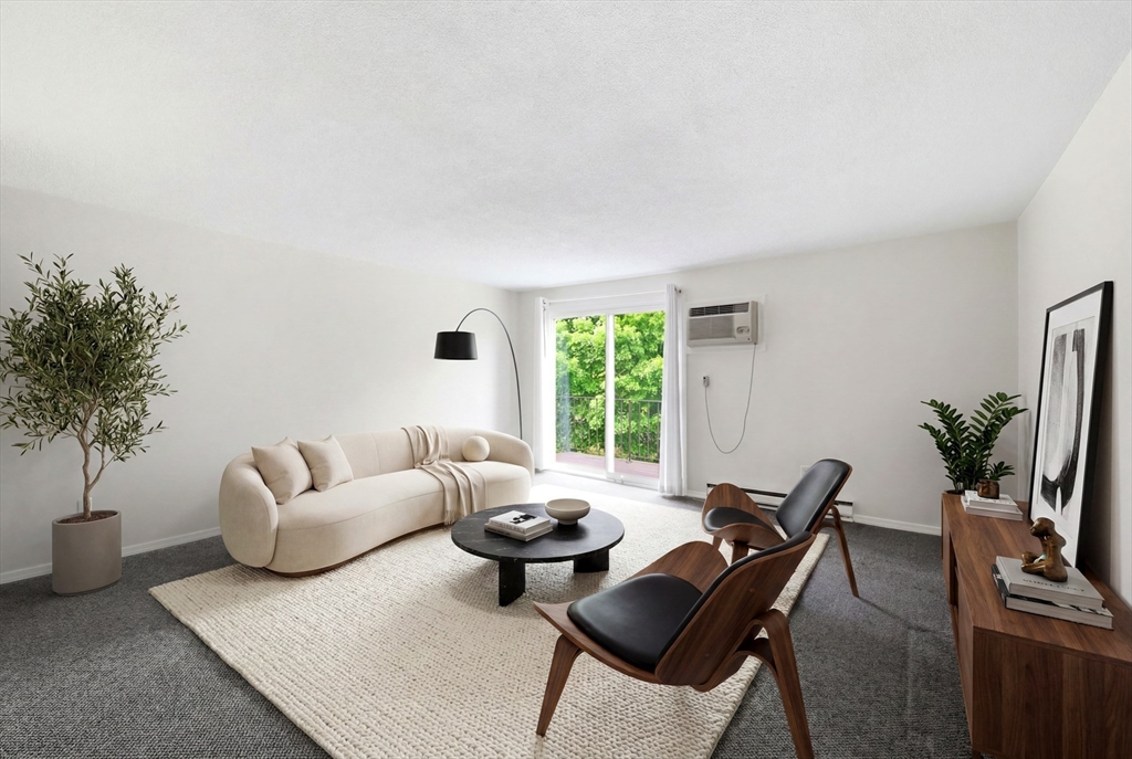 80 Damon Road, Unit 2303 Northampton, MA 01060 - Photo 9 of 23 a living room with furniture and a large window