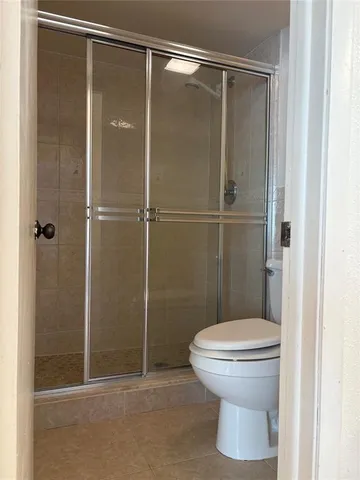 a bathroom that has a toilet and a shower