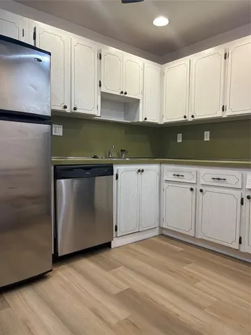 a view of cabinets and wooden floor