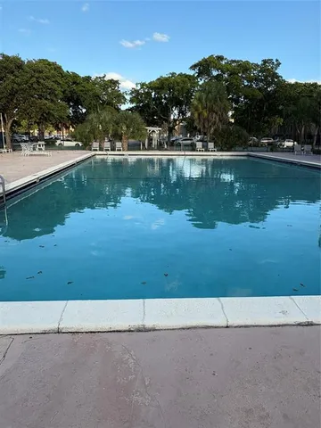 an aerial view of a residential houses with outdoor space and swimming pool