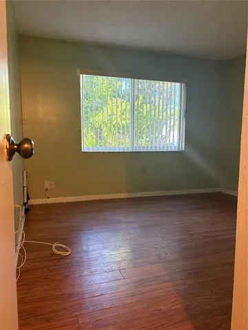 a view of a room with wooden floor and windows