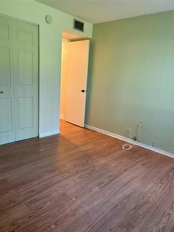 an empty room with wooden floor