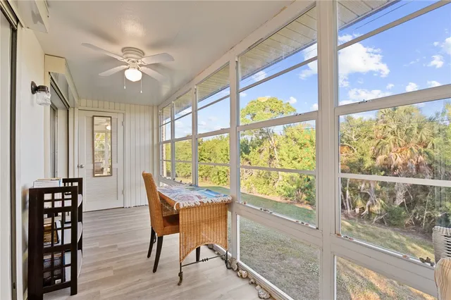 a view of a dining room with furniture water view and wooden floor