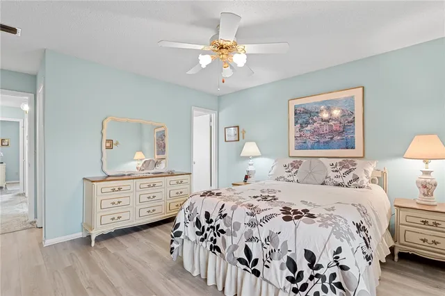 a bedroom with a large bed and a chandelier