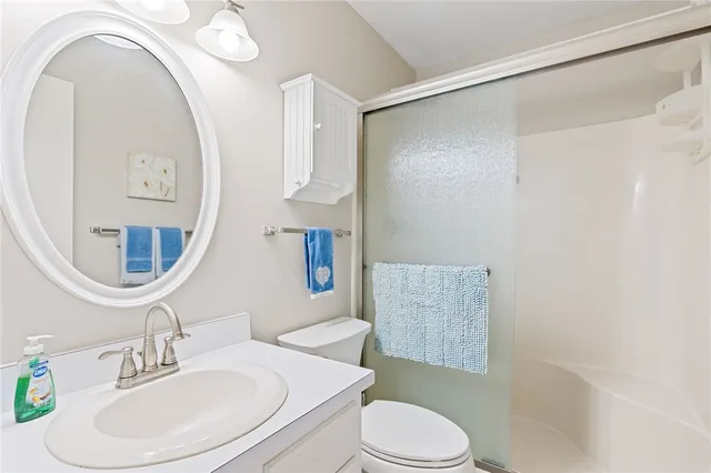 a bathroom with a toilet a sink and a mirror