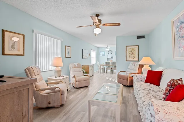 a living room with furniture a rug and a window