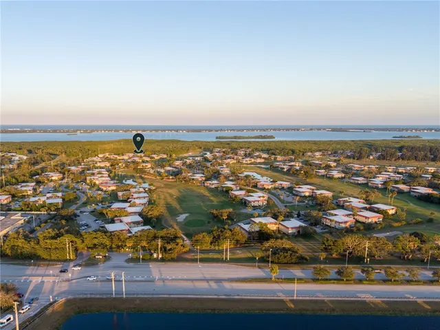 an aerial view of residential building and ocean view