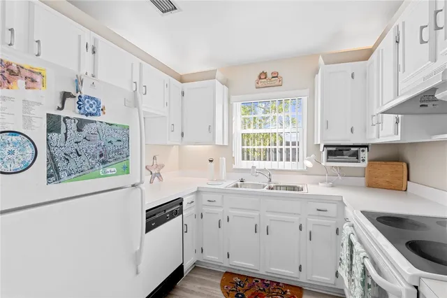 a kitchen with a sink stove top oven and cabinets