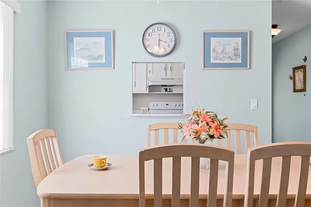 a bedroom with a bed a clock on the wall and a dresser