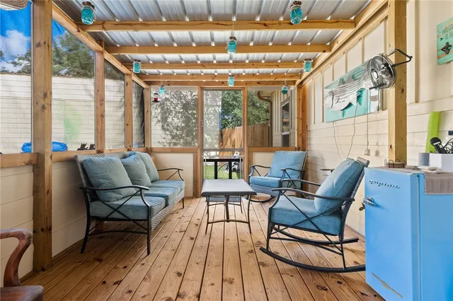 a building outdoor space with patio furniture and wooden floor