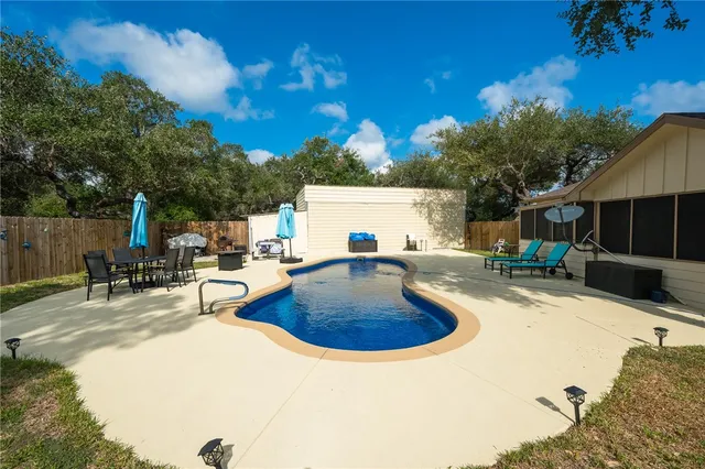 a view of a house with swimming pool and sitting area