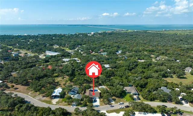 an aerial view of a house with a yard and garden