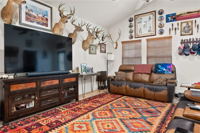 a bedroom with furniture and a flat screen tv