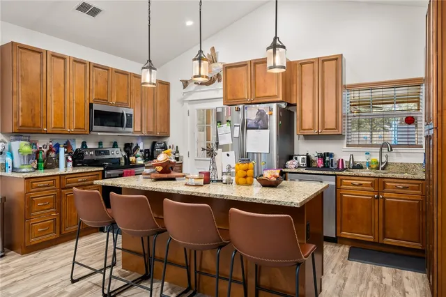 a kitchen with stainless steel appliances granite countertop a stove a sink dishwasher a microwave oven with granite countertops and cabinets