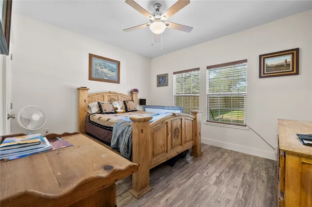 a bedroom with a bed and wooden floor