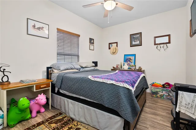 a bedroom with bed and a chandelier