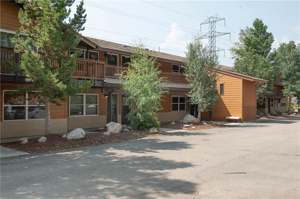 a view of a house with a yard and street