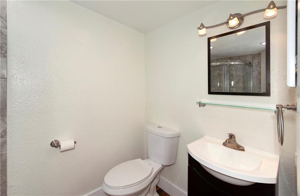 396 Cove Boulevard, Unit 12 Dillon, CO 80435 - Photo 13 of 20 a bathroom with a sink a toilet and mirror