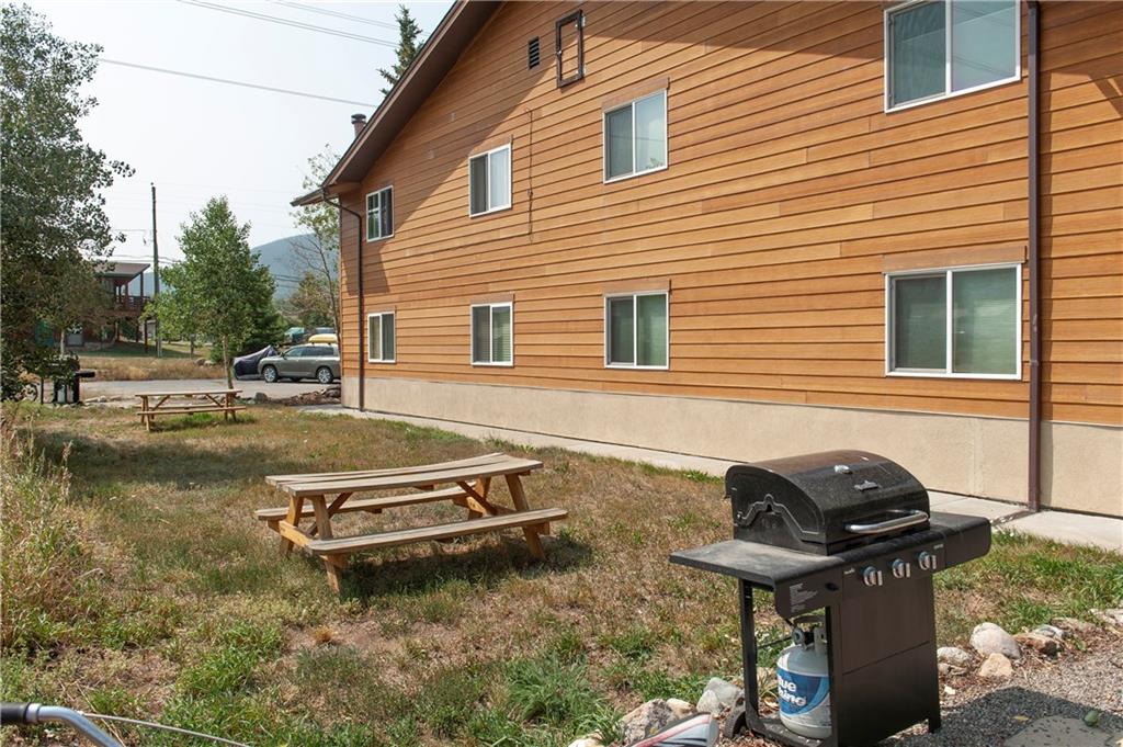 396 Cove Boulevard, Unit 12 Dillon, CO 80435 - Photo 15 of 20 a backyard of a house with barbeque oven and seating space