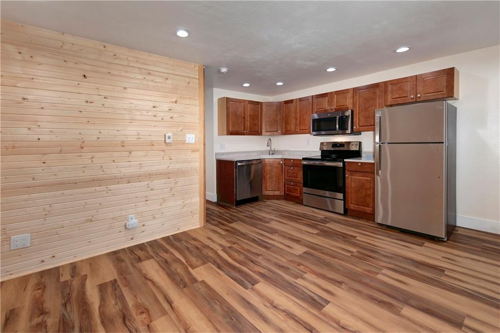 396 Cove Boulevard, Unit 12 Dillon, CO 80435 - Photo 3 of 20 a kitchen with stainless steel appliances a refrigerator and a stove top oven