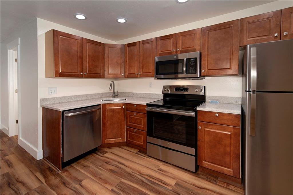396 Cove Boulevard, Unit 12 Dillon, CO 80435 - Photo 4 of 20 a kitchen with stainless steel appliances granite countertop a stove a refrigerator and a microwave
