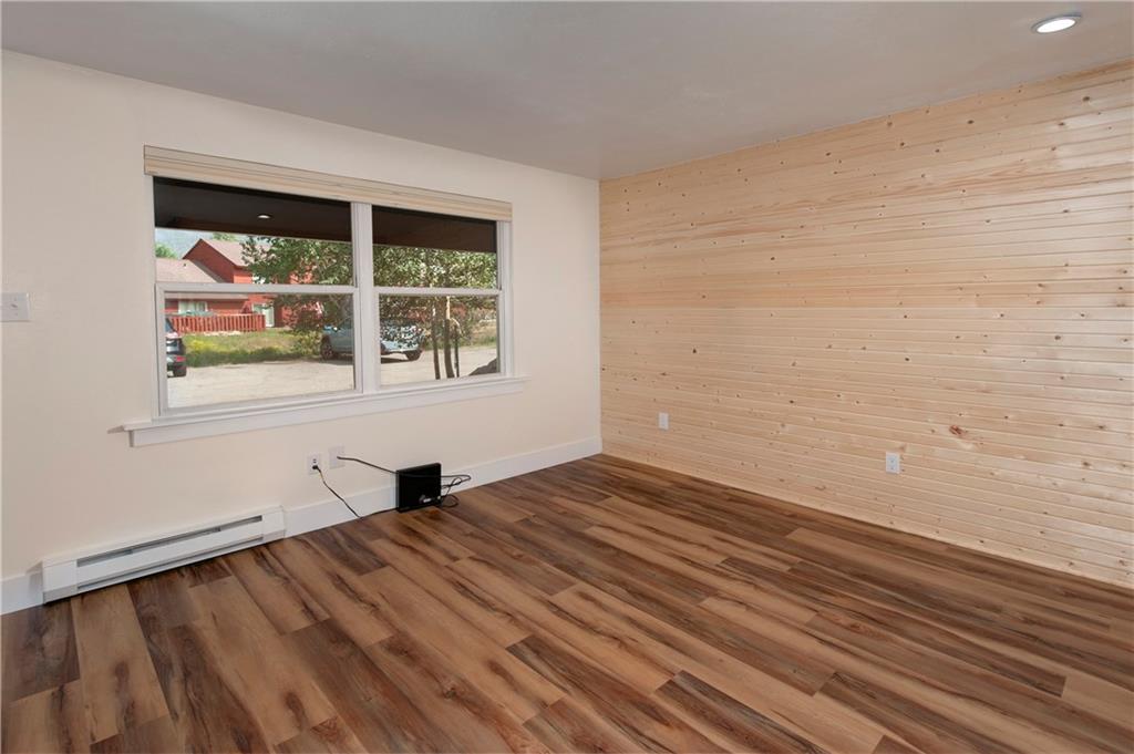 396 Cove Boulevard, Unit 12 Dillon, CO 80435 - Photo 6 of 20 a view of an empty room with wooden floor and a window
