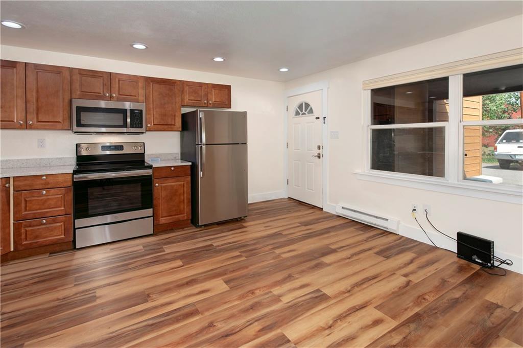 396 Cove Boulevard, Unit 12 Dillon, CO 80435 - Photo 7 of 20 a kitchen with stainless steel appliances a stove top oven a refrigerator and a cabinets with wooden floor