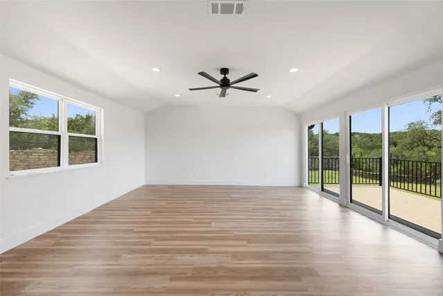 a view of a livingroom with a ceiling fan and window