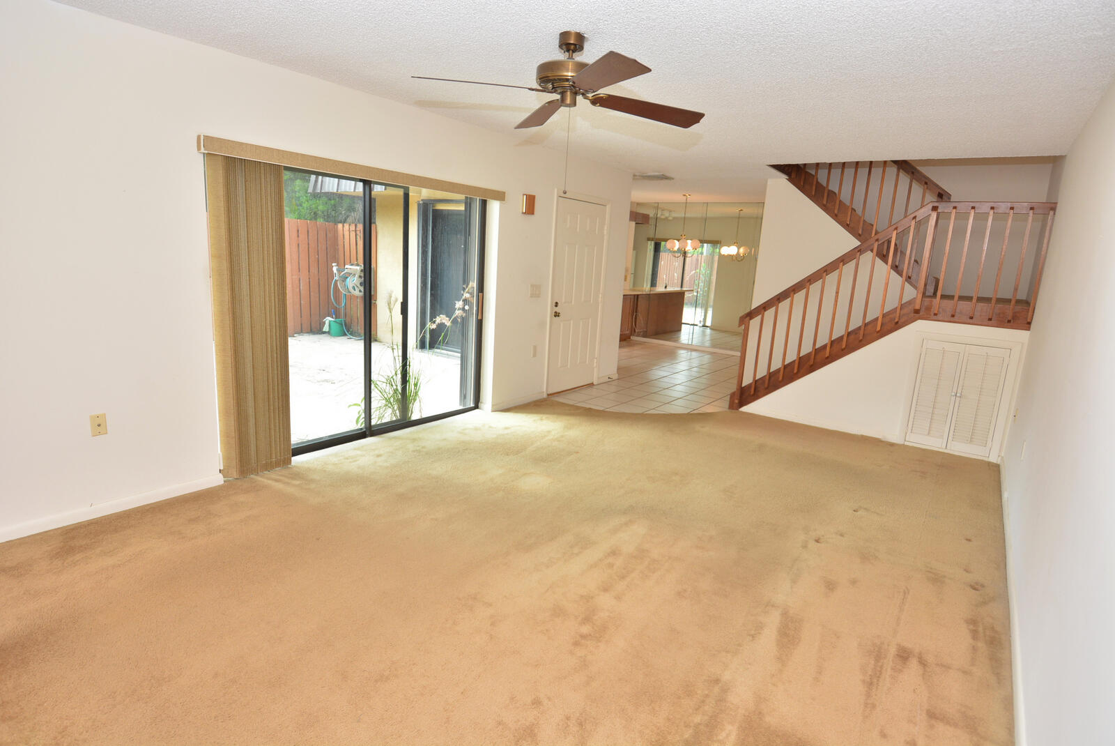 5806 Southeast Windsong Lane, Unit 217 Stuart, FL 34997 - Photo 15 of 42 a view of an empty room with wooden floor and a ceiling fan