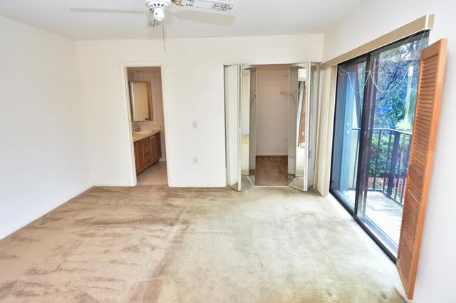 a view of an empty room and a bathroom