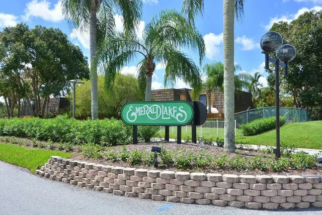 a picture of a building with a big yard and large trees