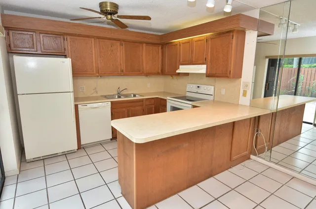 a kitchen with a sink a refrigerator and a stove