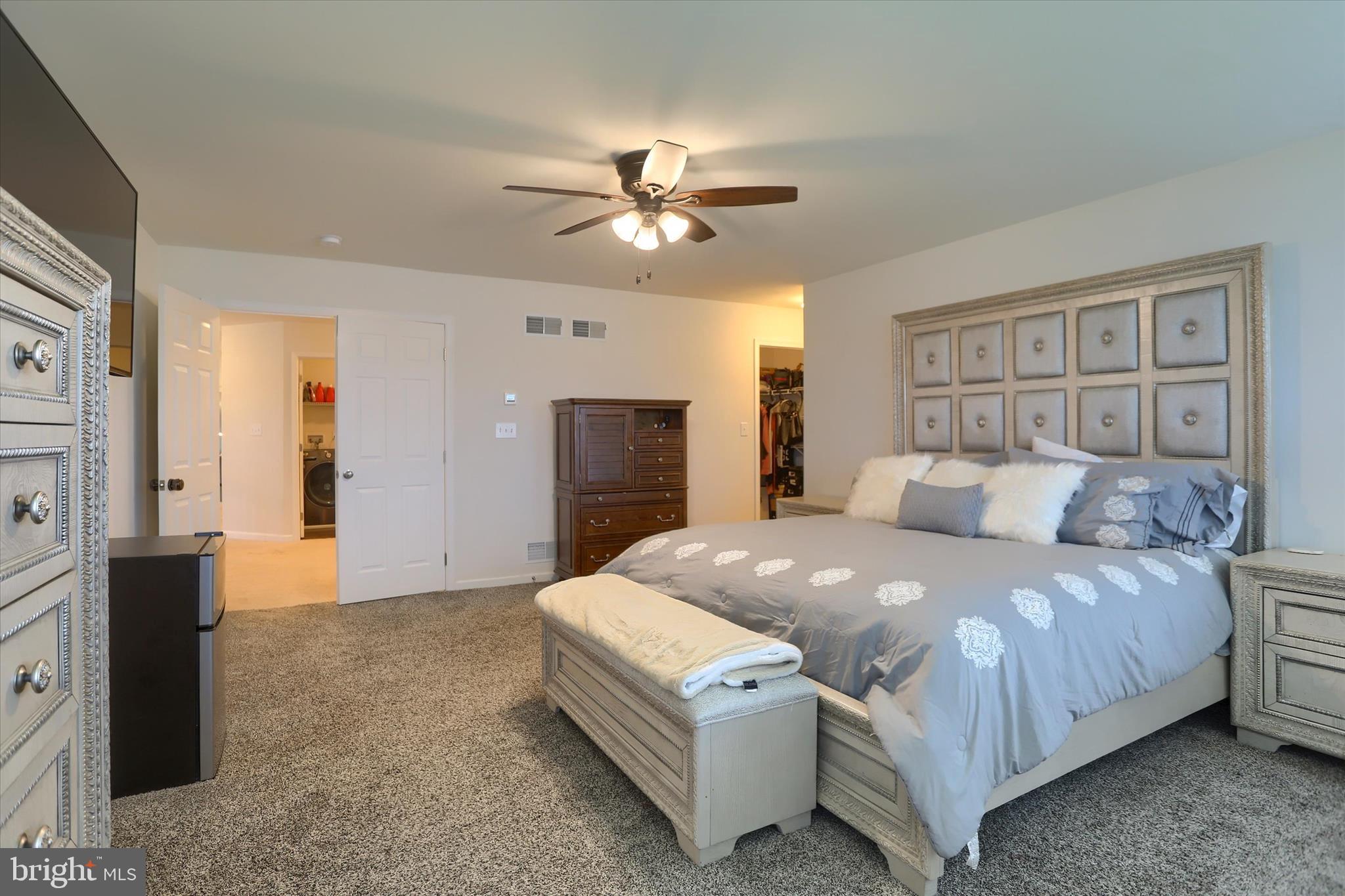 515 Darrow Road York, PA 17404 - Photo 27 of 41 a spacious bedroom with a bed and a chandelier