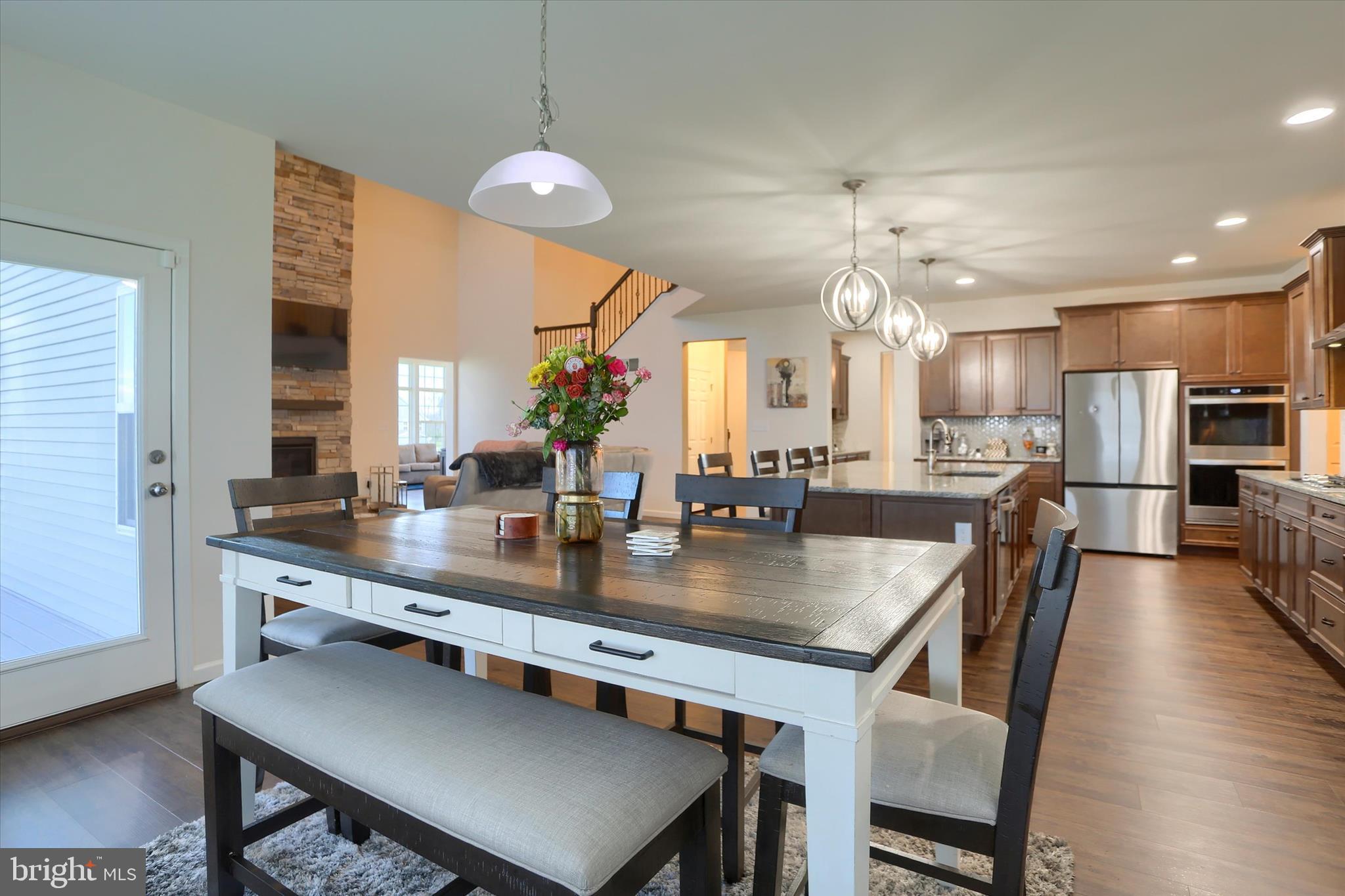 515 Darrow Road York, PA 17404 - Photo 9 of 41 a kitchen with stainless steel appliances granite countertop a dining table chairs sink and wooden floor