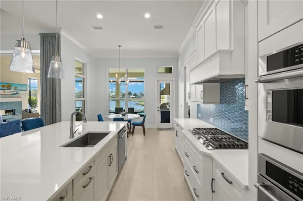 a kitchen with a stove a sink and a refrigerator