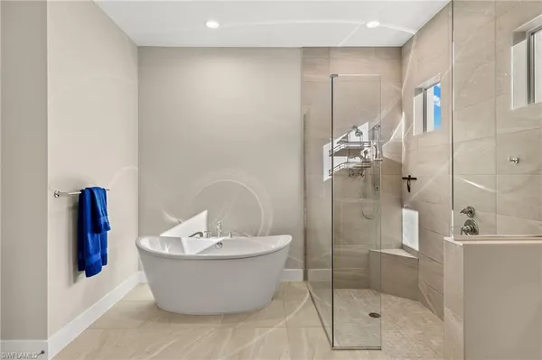 a bathroom with a bathtub and shower