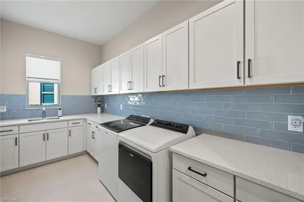 a kitchen with a sink stove and cabinets