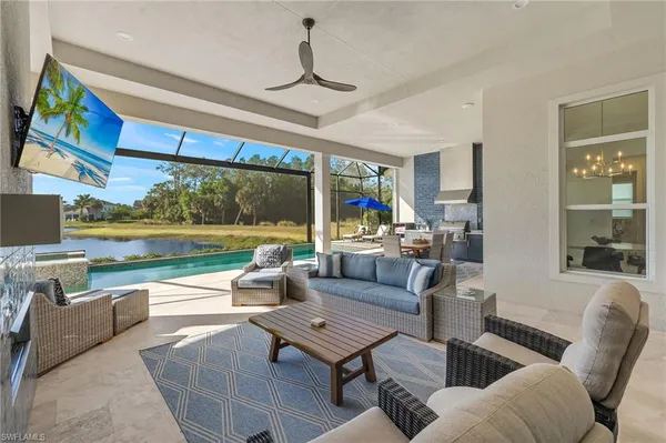 a living room with patio furniture and a floor to ceiling window
