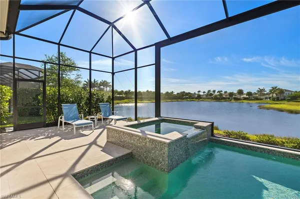 a view of a swimming pool with a couches in a patio