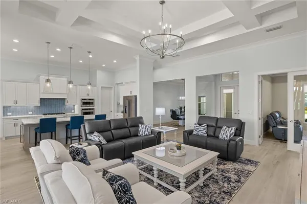 a living room with furniture or kitchen and a chandelier