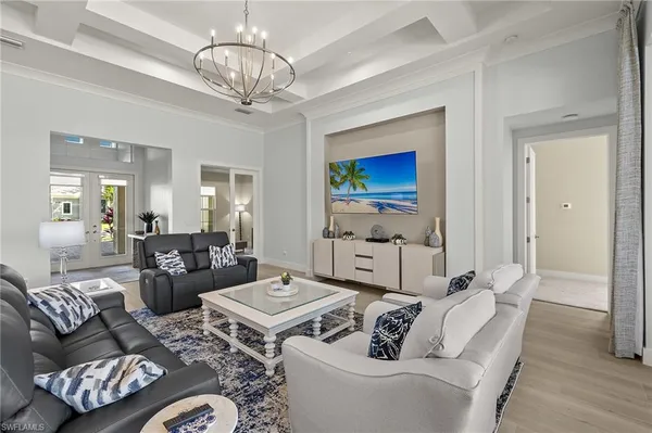 a living room with furniture chandelier and a chandelier