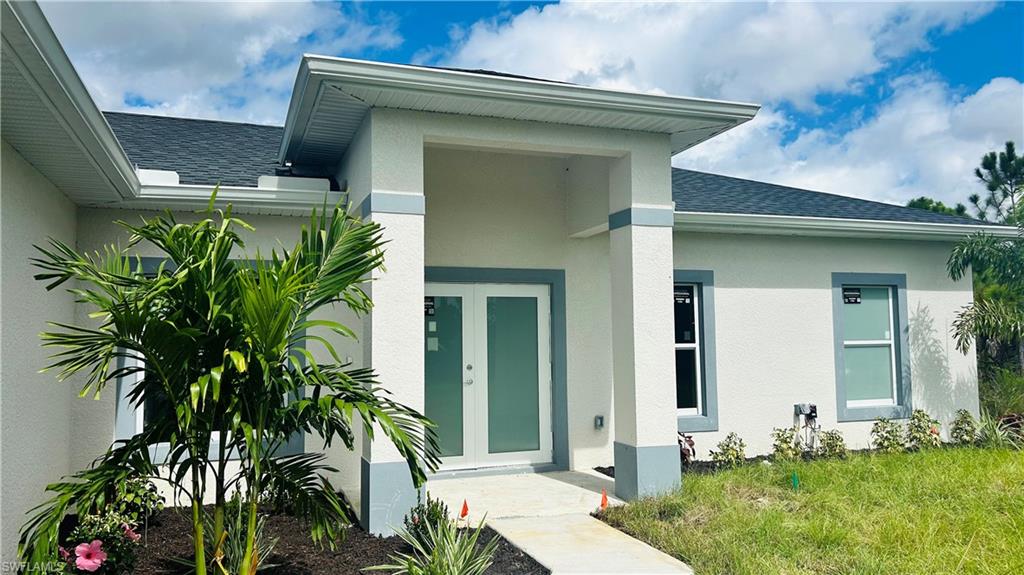 4341 64th Avenue Northeast Naples, FL 34120 - Photo 2 of 9 a front view of a house with garden