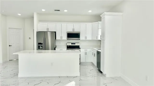 a kitchen with stainless steel appliances cabinets a sink and a counter top space